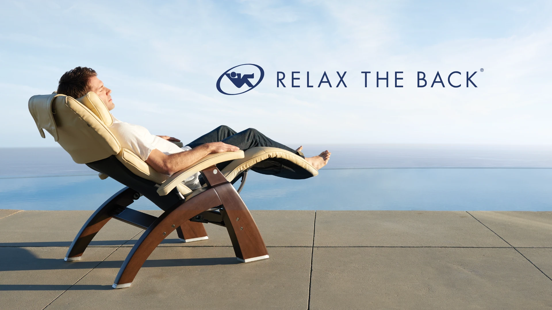 Man reclining in a Perfect Chair Zero Gravity recliner by the ocean