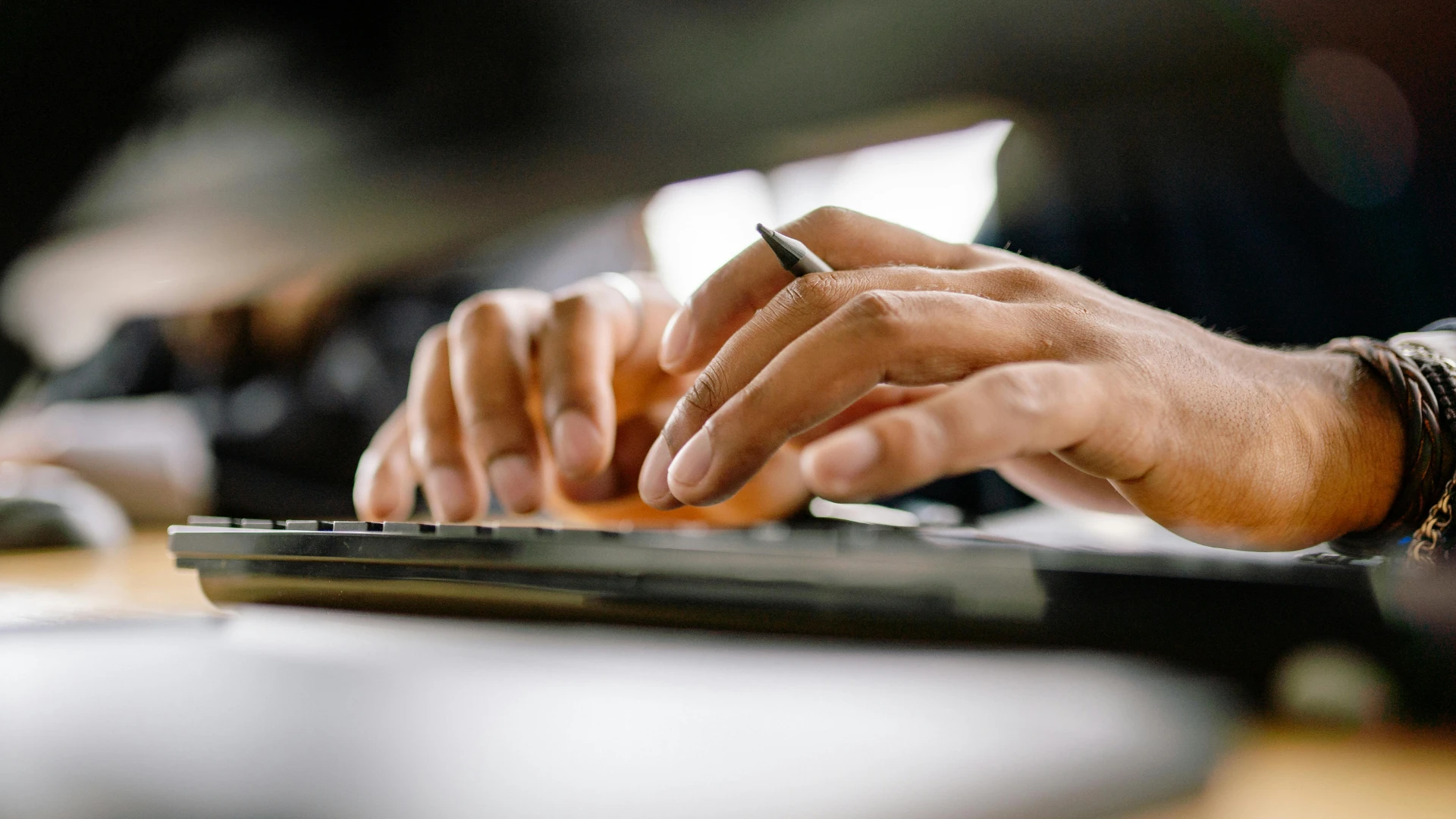 Hands typing at an ergonomic workstation
