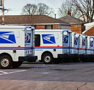 US Postal trucks in a parking lot