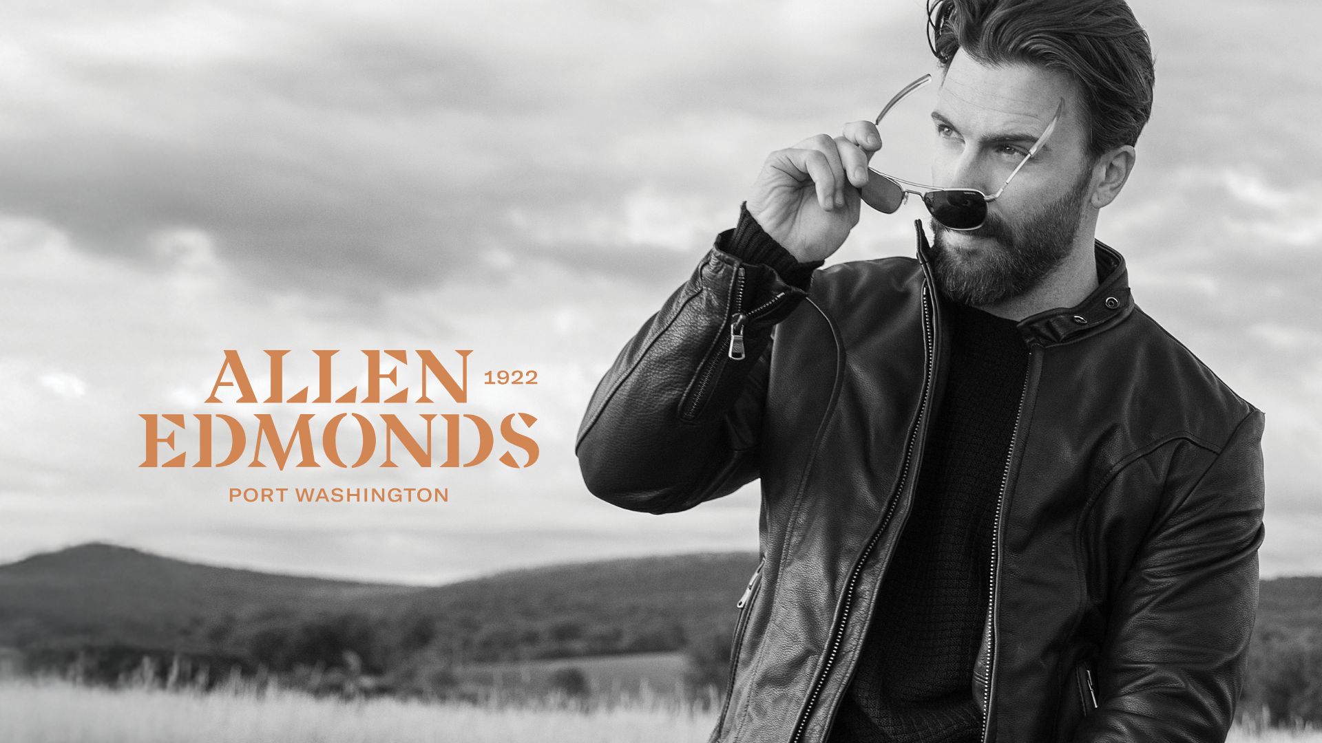 allen edmonds logo and man putting on sunglasses