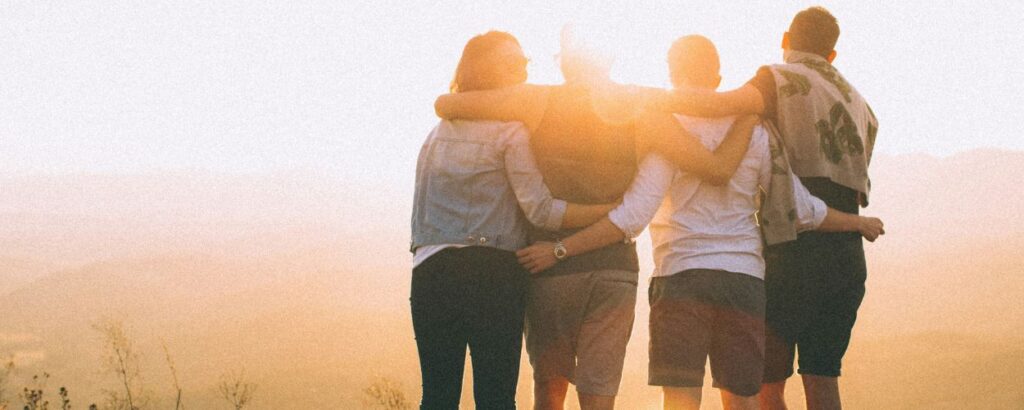 4 people in front of a sunset