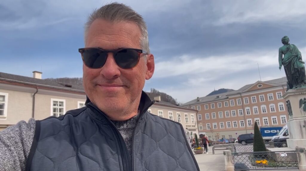 standing in front of statue in Salzburg branding lesson